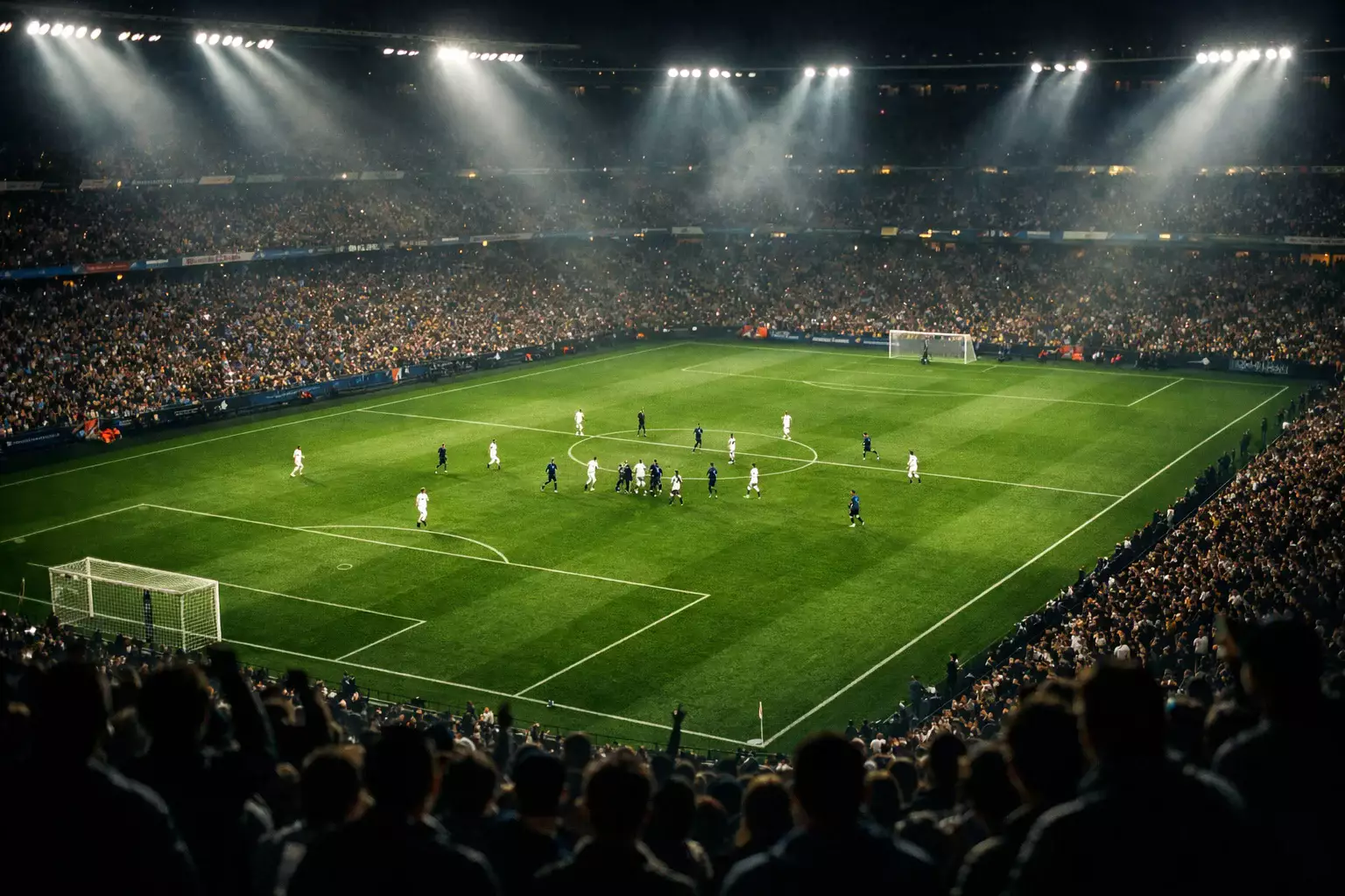 Stadio di calcio illuminato durante una partita in diretta con tifosi sugli spalti